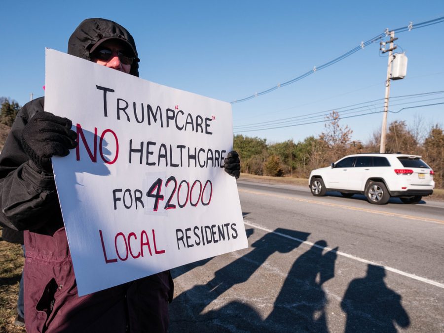 An+individual+protesting+TrumpCare+stating+how+many+people+would+negatively+be+affected+by+it.+