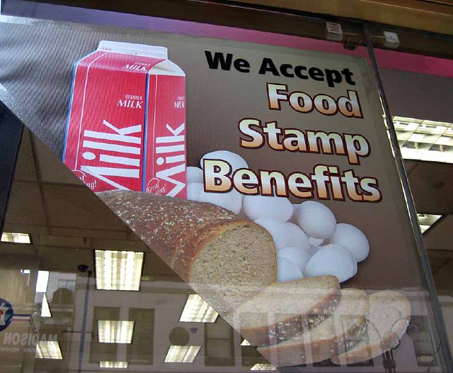 Taken in 2007, a grocery store hangs up a sign in their windows saying they accept food stamp benefits. If Trump’s new policy goes into effect, many Americans will be unable to use their food stamps to buy food in grocery stores.