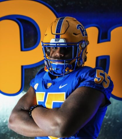 Francis Brewu gets suited up in Pitt gear during his visit this spring. 