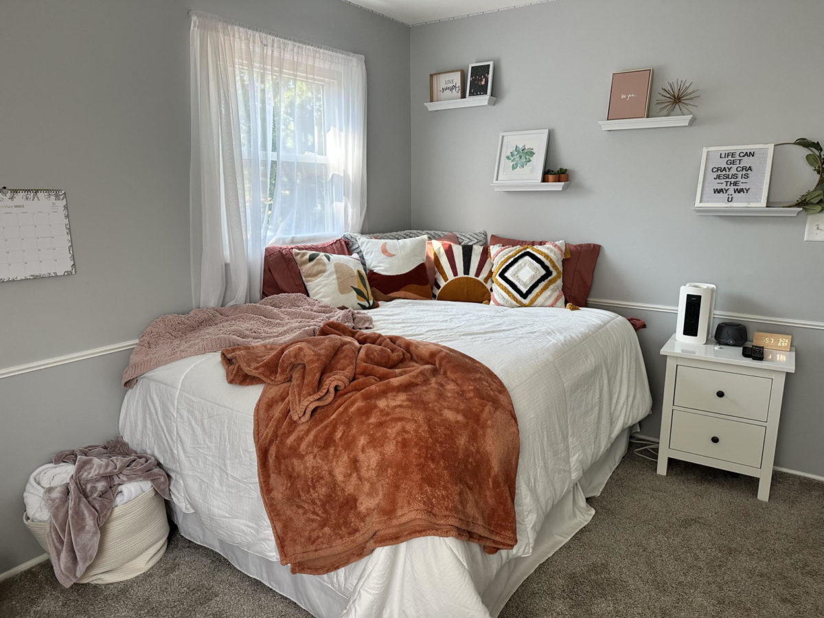Abby Dulgar’s bed is a comfy spot making it the ideal place to wind down after a long day. Its warm color palette along with the natural light from the window makes the space inviting. Not to mention, a made bed is the best way to start your day. 
