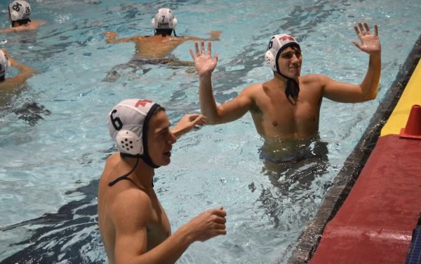 Seniors Chase Kucinski (Left) and Nathan Edwards (Right) strategize for water polo during a regular season match. Kucinski does a lot of extracurricular activities and water polo is just the tip of the iceberg.