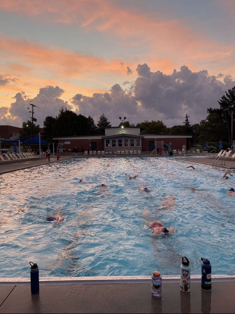 The sun rises above the Worthington Pool, as the TWHS waterpolo teams participate in their morning practice routines.