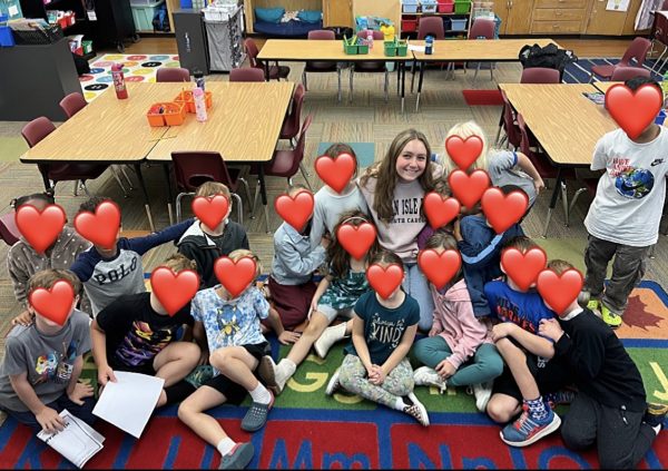 High School Senior Lily McAlister with students at Colonial Hills Elementary at the beginning of her volunteer activities for the school year.