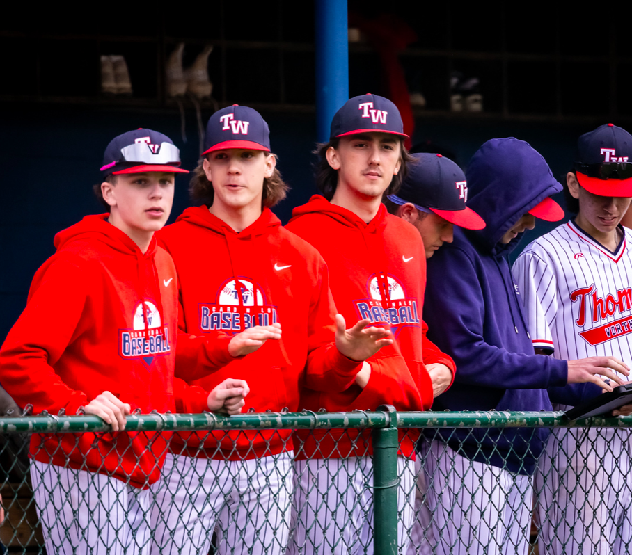 Zane Graven and Braeden Schmidt in the dugout with teamate, Will Loadman